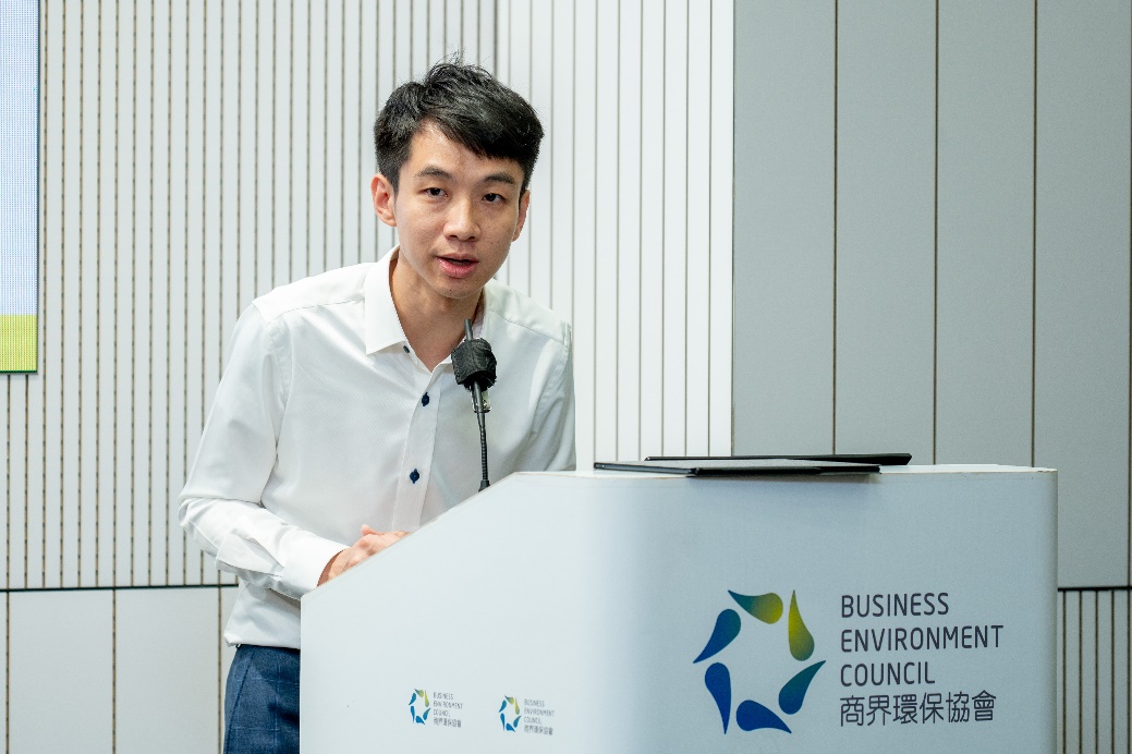 A person standing at a podium

Description automatically generated