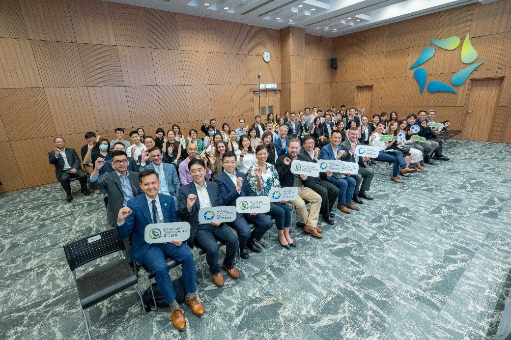 A group of people sitting in chairs holding signs

Description automatically generated